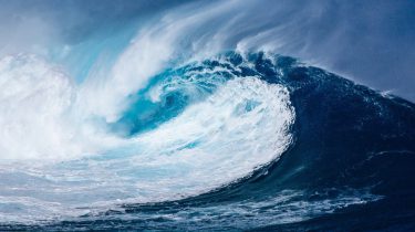 A large rolling wave from the ocean crashing
