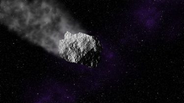 An asteroid traveling through space and ablating some material