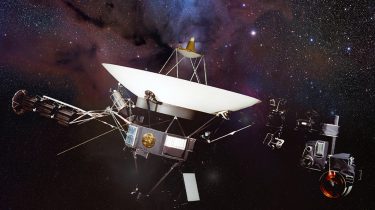 An artist's illustration of the Voyager spacecraft in space with a nebula and stars in the background